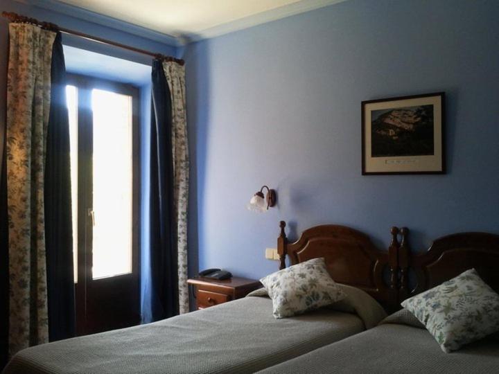 Postel nebo postele na pokoji v ubytování Hostal de la Rovira