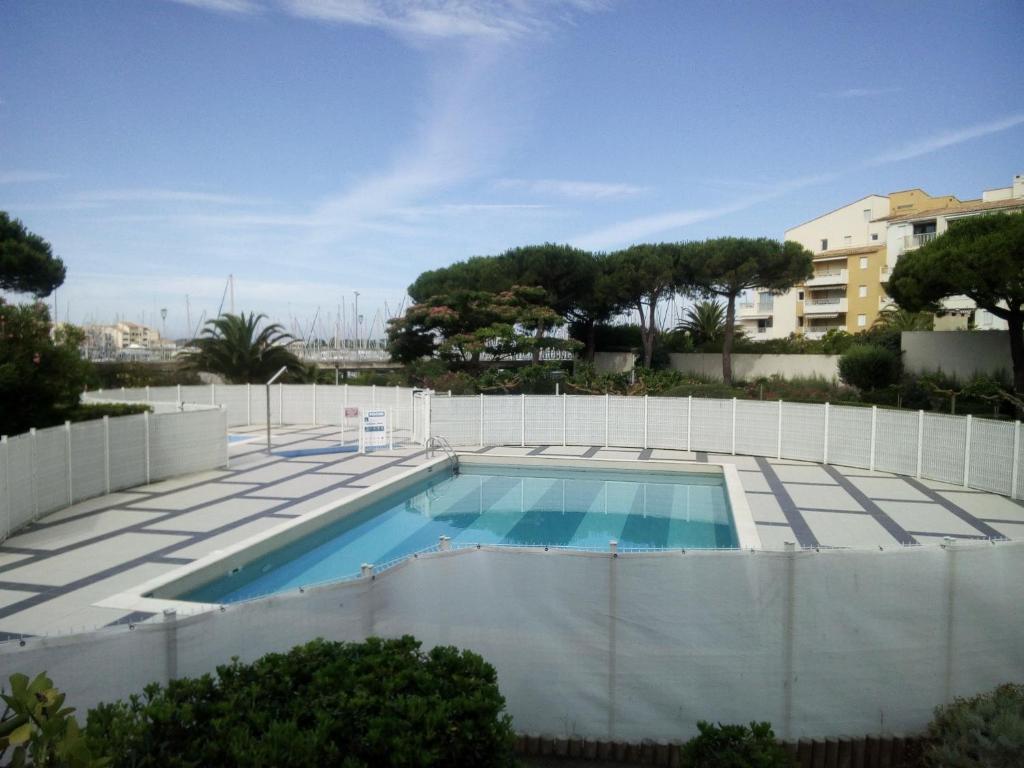 a swimming pool on the roof of a house at T3 Duplex, centre port, clim, garage, piscine in Cap d'Agde