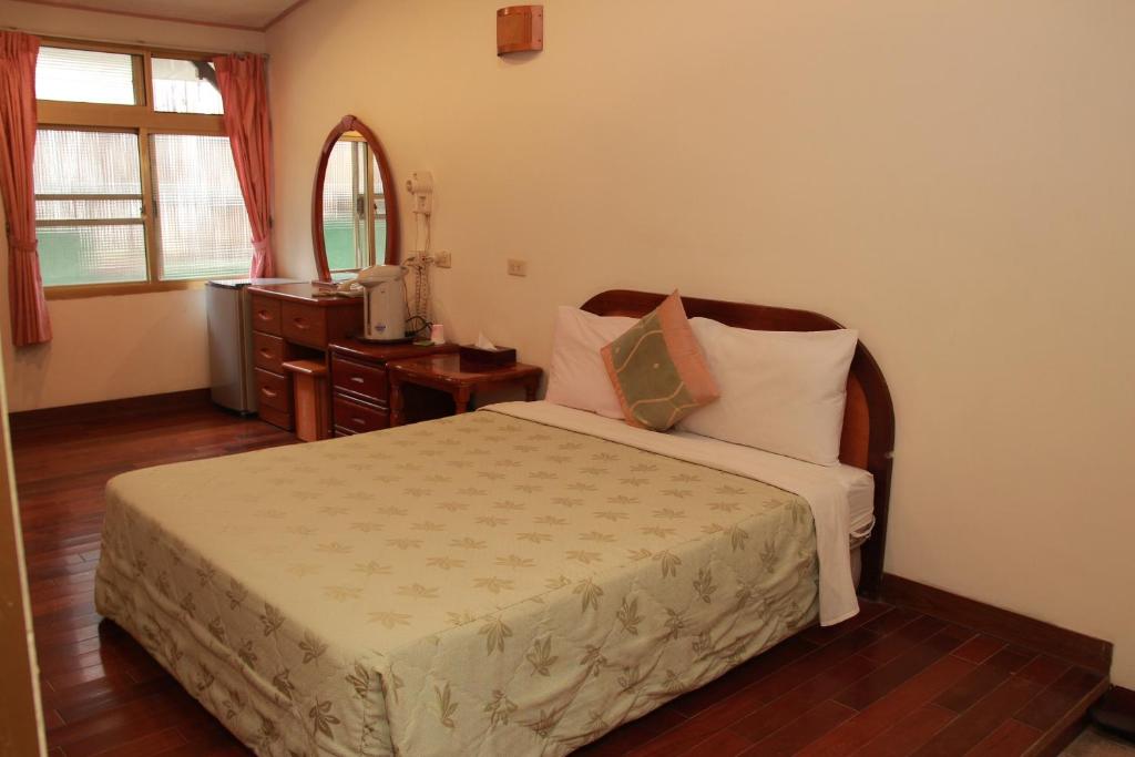 Postel nebo postele na pokoji v ubytování Qingxiu Hotel