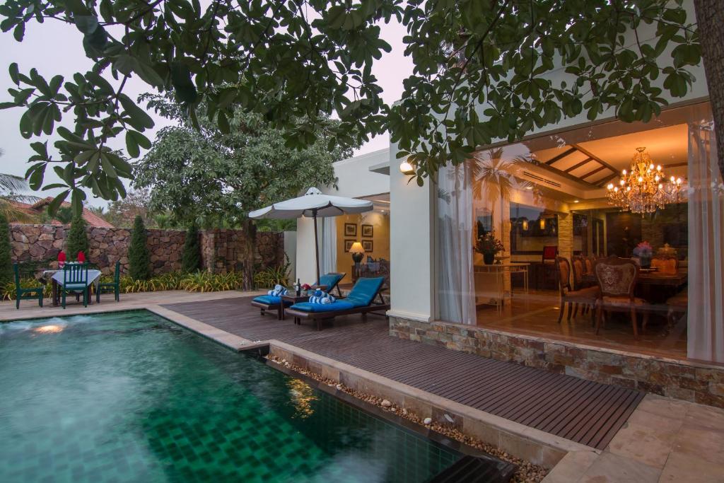a house with a swimming pool and a patio at Angkor Palace Suite & Villa in Siem Reap