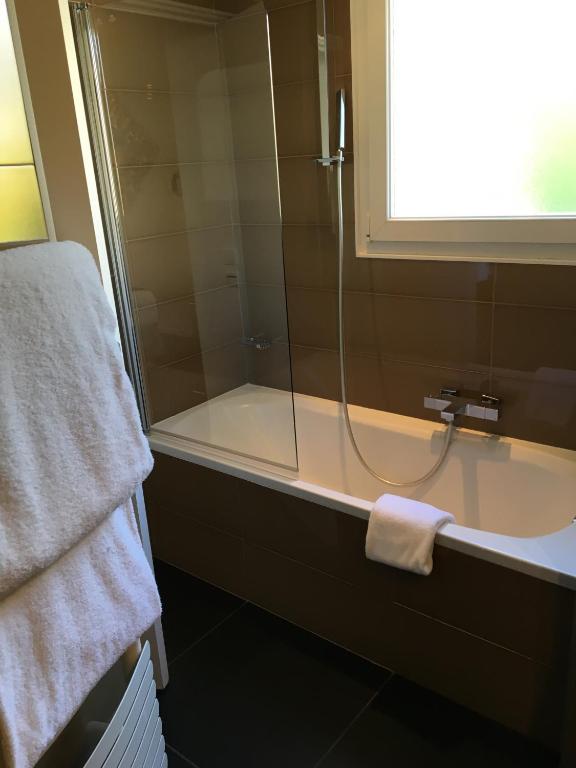 a bathroom with a shower and a tub and a sink at Hôtel La Villa Cannes in Cannes