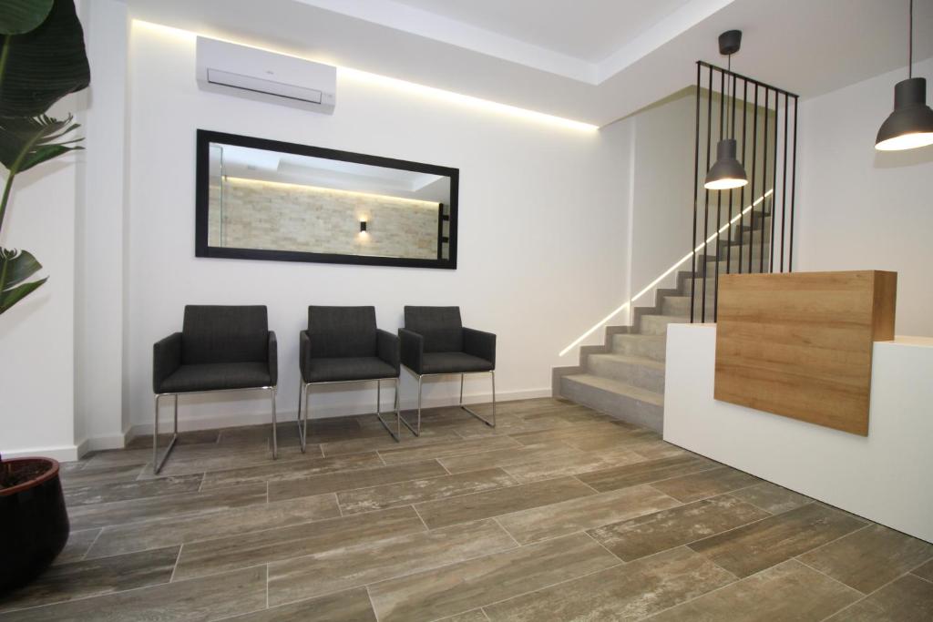 a waiting room with three chairs and stairs at Alojamientos Santa Pola in Santa Pola