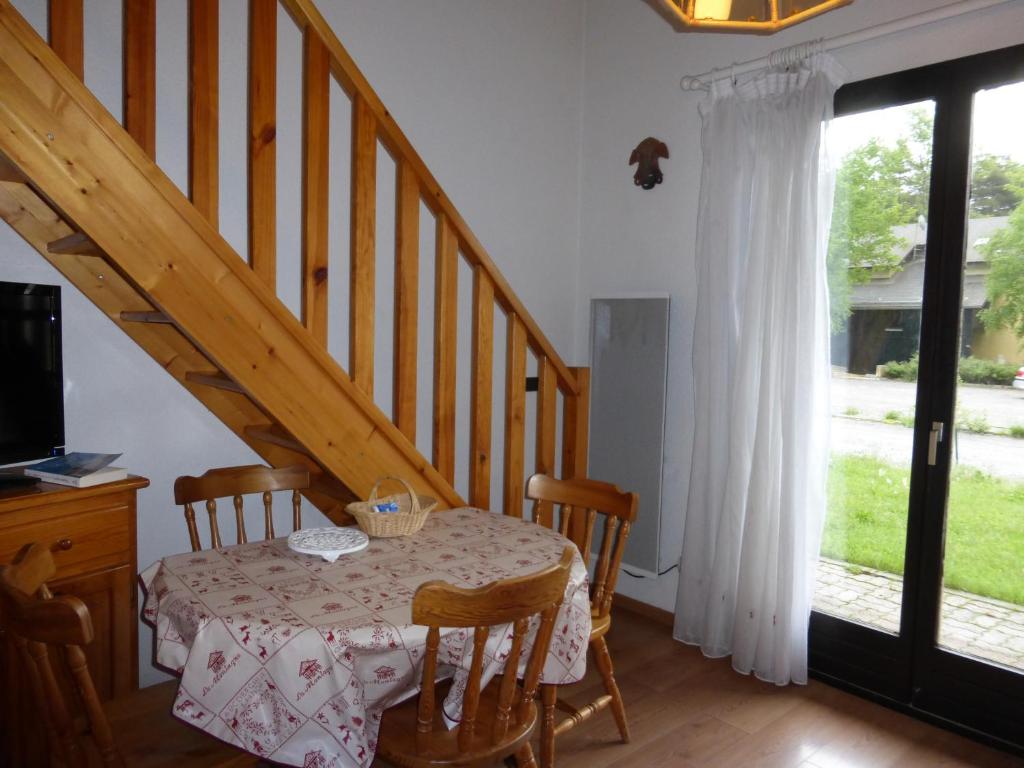 a dining room with a table and a staircase at JAUSIERS VILLAGE G 2 in Jausiers