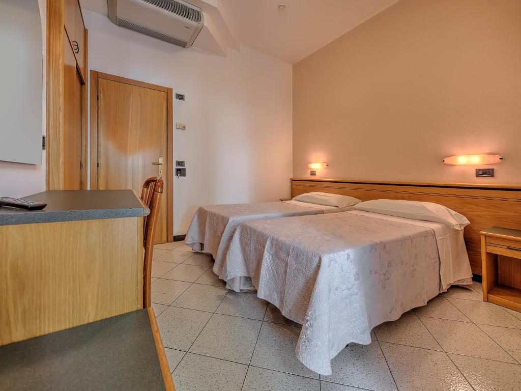 Posteľ alebo postele v izbe v ubytovaní Hotel Excelsior