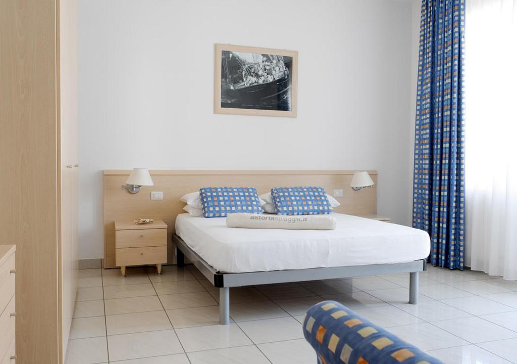 a bedroom with a bed with blue pillows at Casa Lucia Centro Apartment Deluxe in Sottomarina