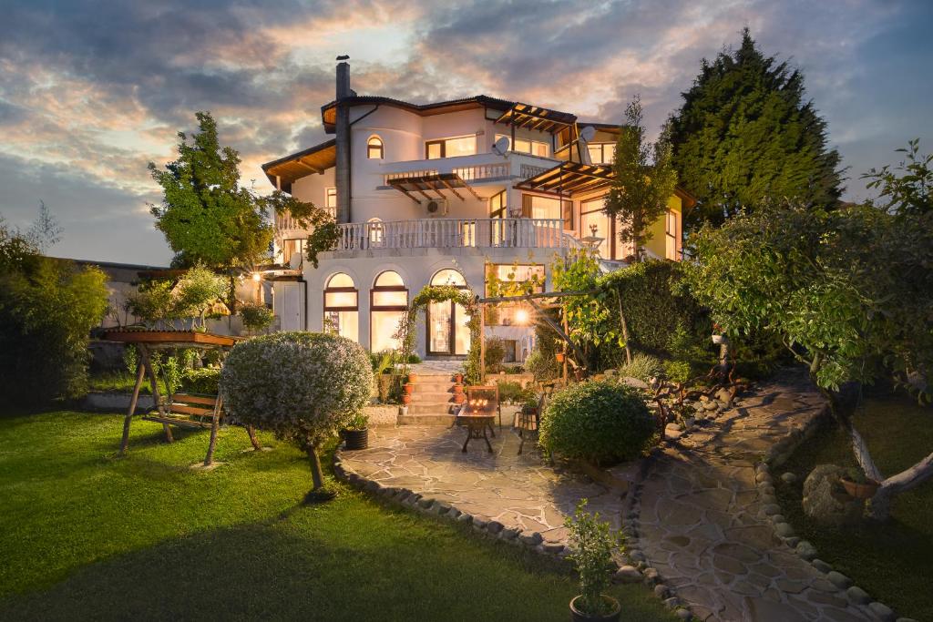 a large white house with a garden in front of it at Villa Zelenika in Sinemorets