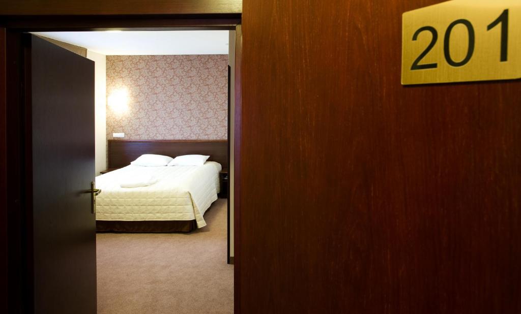 Postel nebo postele na pokoji v ubytování Hotel Centrum