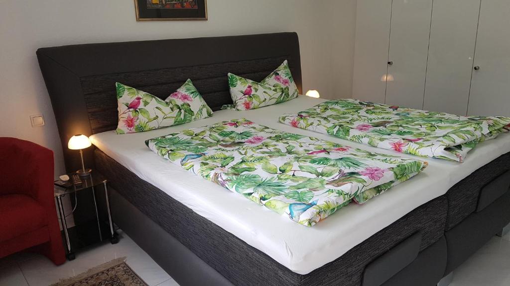 a large bed with two pillows on top of it at Loft Orchidee in Überlingen