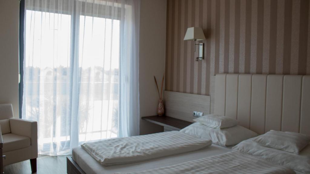 Posteľ alebo postele v izbe v ubytovaní Gokart Hotel