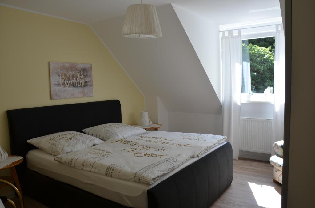 a bedroom with a bed with a white comforter at Moni's Ferienwohnung in Bad Bertrich