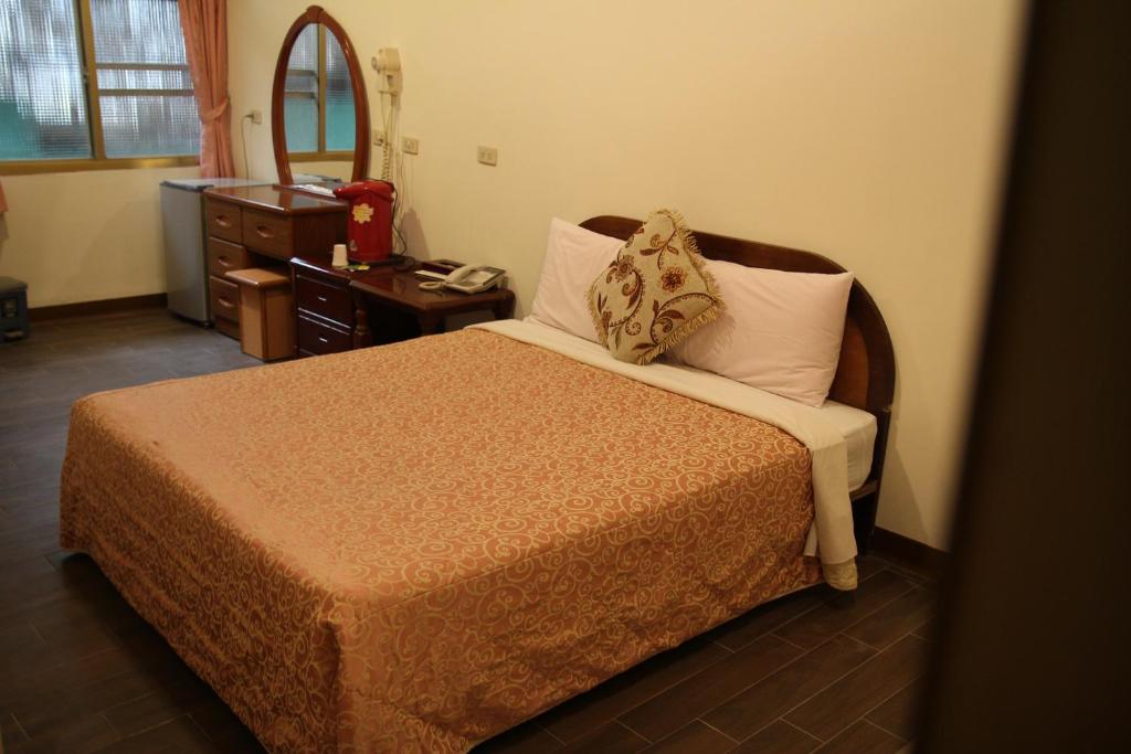 Postel nebo postele na pokoji v ubytování Qingxiu Hotel