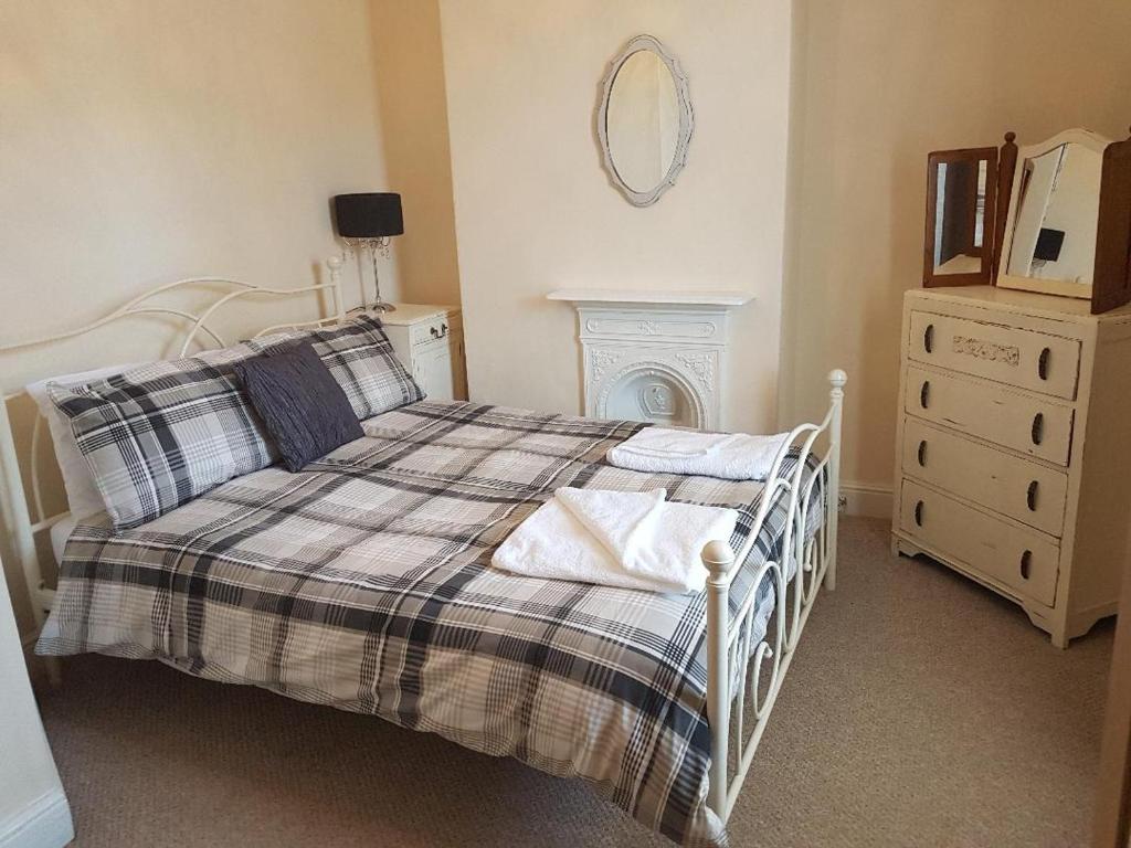 a bedroom with a bed and a dresser and a mirror at No7 Agar Street in York