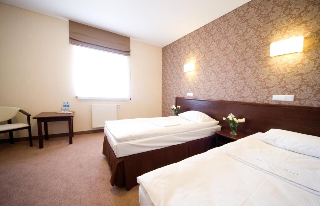 Postel nebo postele na pokoji v ubytování Hotel Centrum