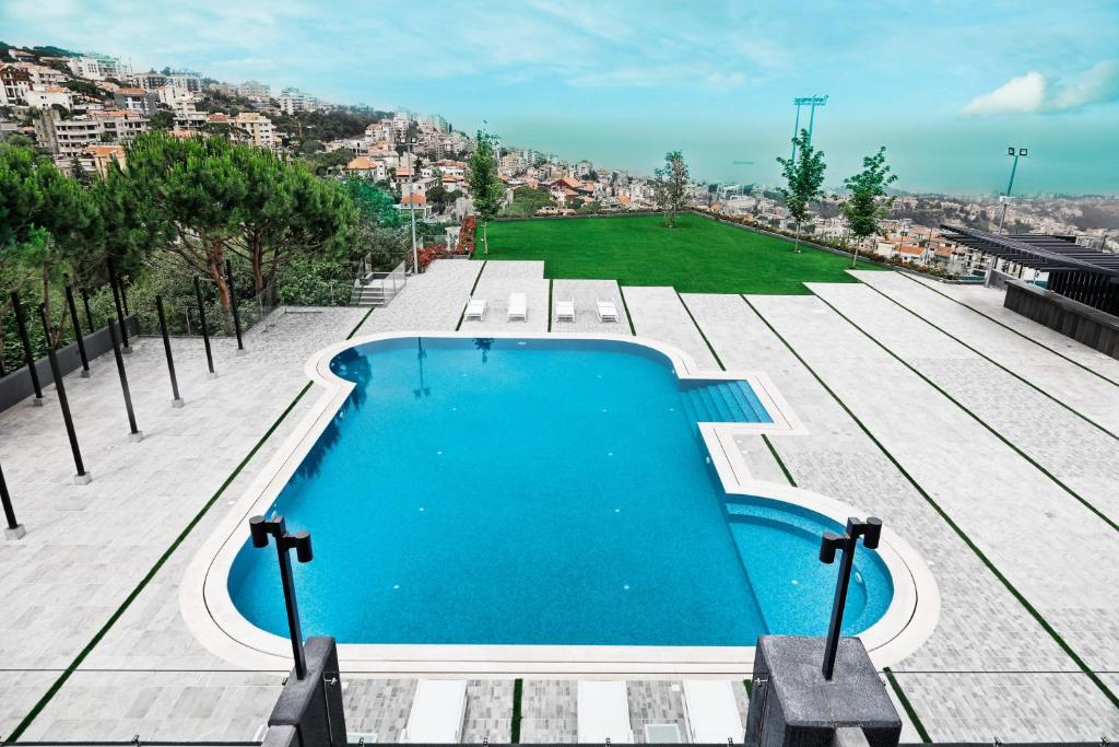 a swimming pool on the roof of a building at Le Pave Residences in Bayt al Kūkū