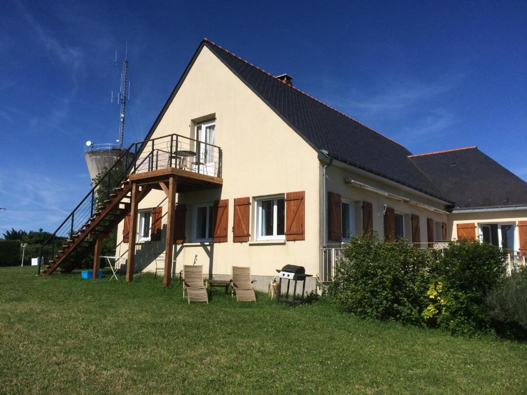 a house with a staircase and a water tower at Les petits chenes in La Pellerine