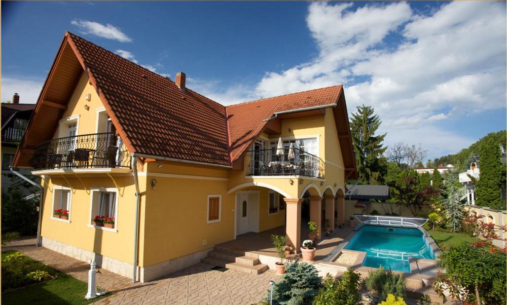 a house with a swimming pool in the backyard at Villa Mikes Siófok in Siófok