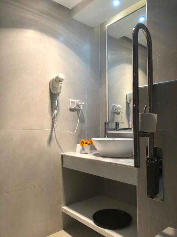 a bathroom with a sink and a mirror at Hotel La Residence Hammamet in Hammamet