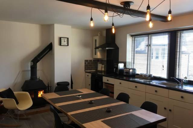 a kitchen with a table and a kitchen with a stove at @ No.4 in Castle Cary