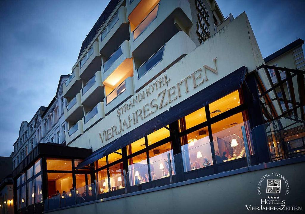 a building with a sign on the side of it at Strandhotel VierJahresZeiten in Borkum