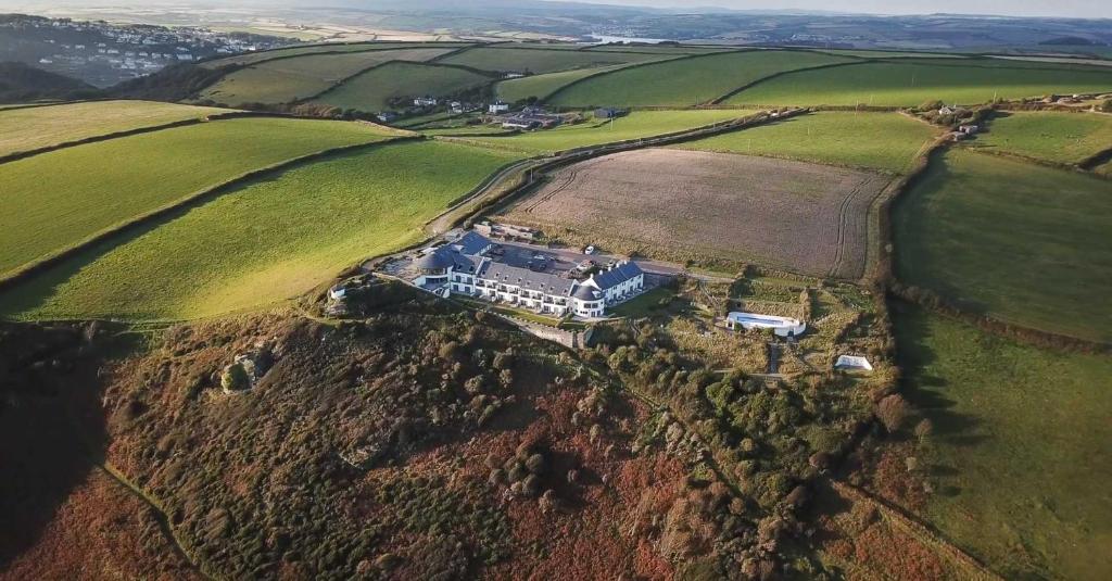 an aerial view of a large house on a hill at Gara Rock in Salcombe