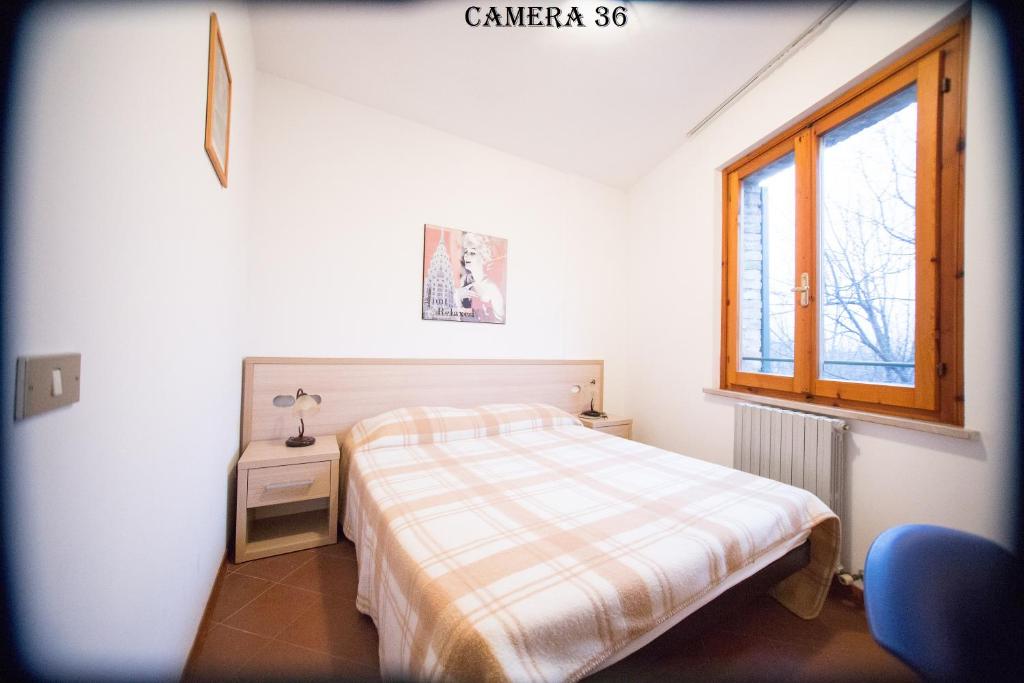 Posteľ alebo postele v izbe v ubytovaní Hotel I Tigli albergo diffuso