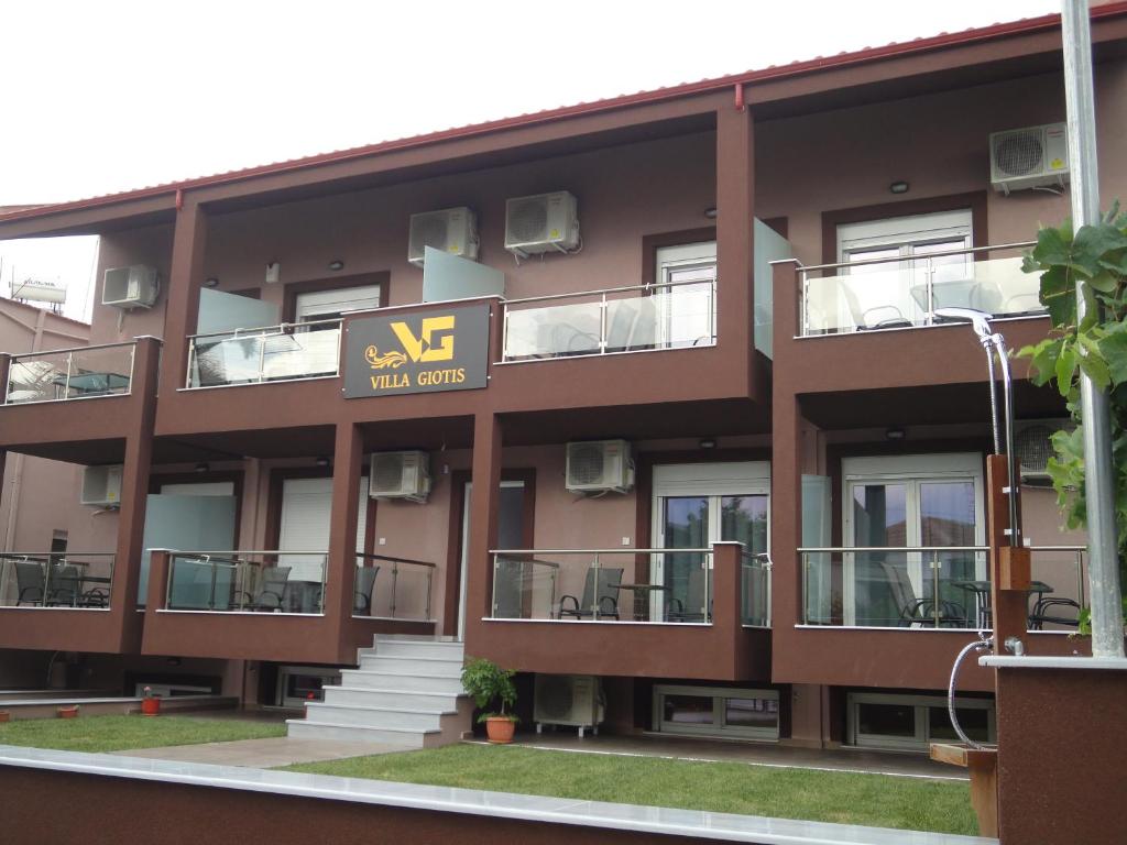 an apartment building with a xv hotel sign on it at Villa Giotis in Skala Sotiros
