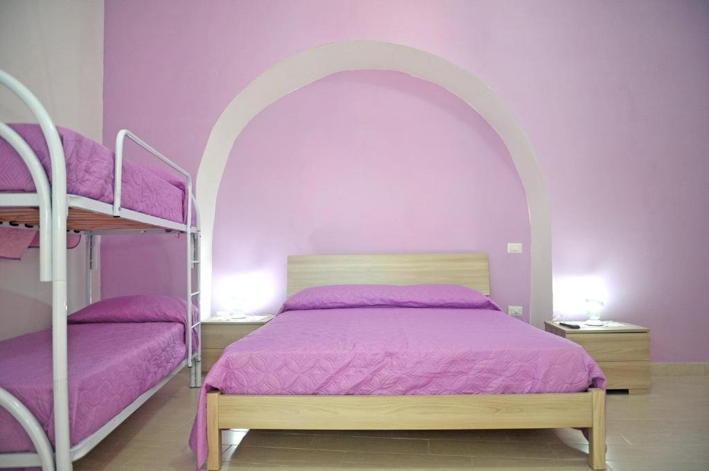 A bed or beds in a room at casa vacanze"IL TRAMONTO"