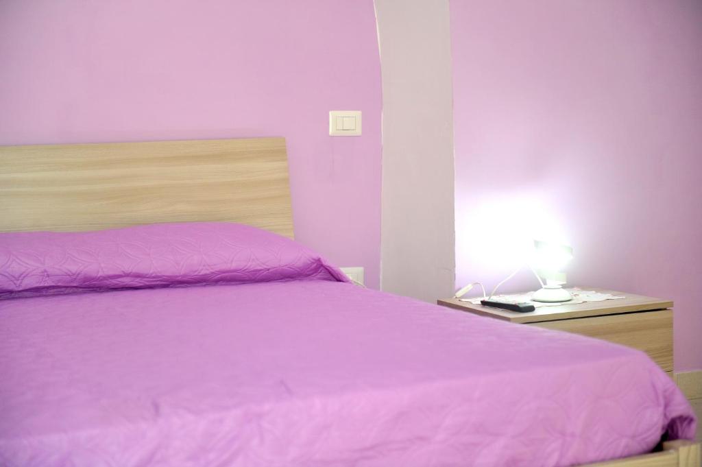 A bed or beds in a room at casa vacanze"IL TRAMONTO"