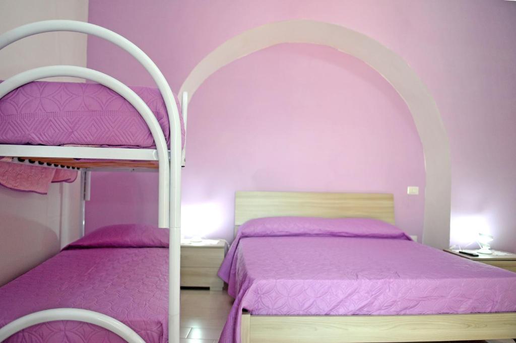 A bed or beds in a room at casa vacanze"IL TRAMONTO"