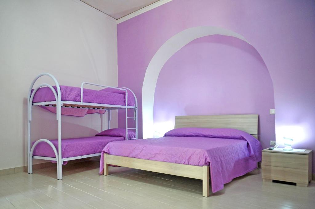 A bed or beds in a room at casa vacanze"IL TRAMONTO"