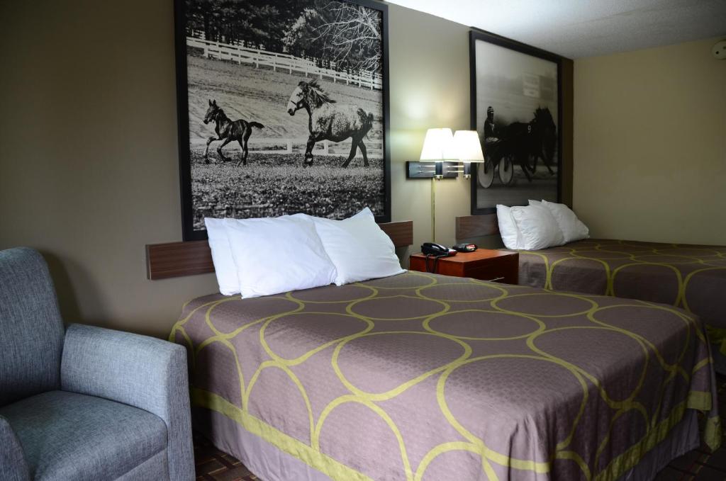 a hotel room with a bed and a chair at Super 8 by Wyndham Franklin Hwy 31 in Franklin