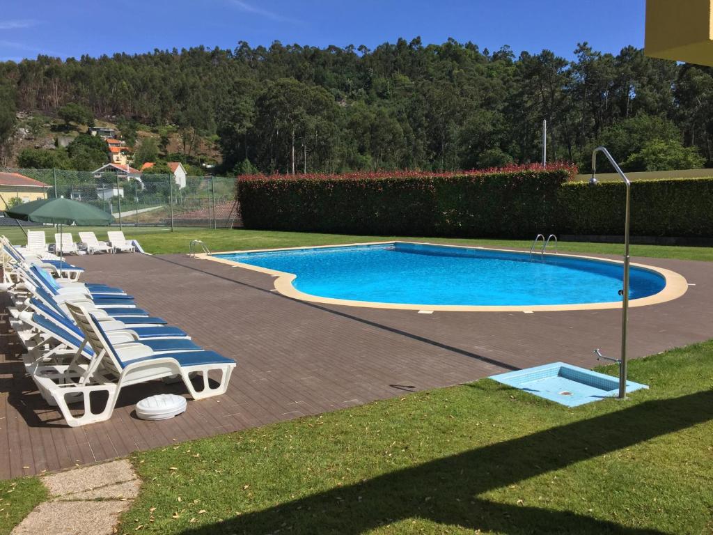 a group of lounge chairs and a swimming pool at Quinta da Boavista in Caminha