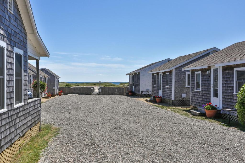 a driveway of houses in a row at Truro Beach Cottages in Truro