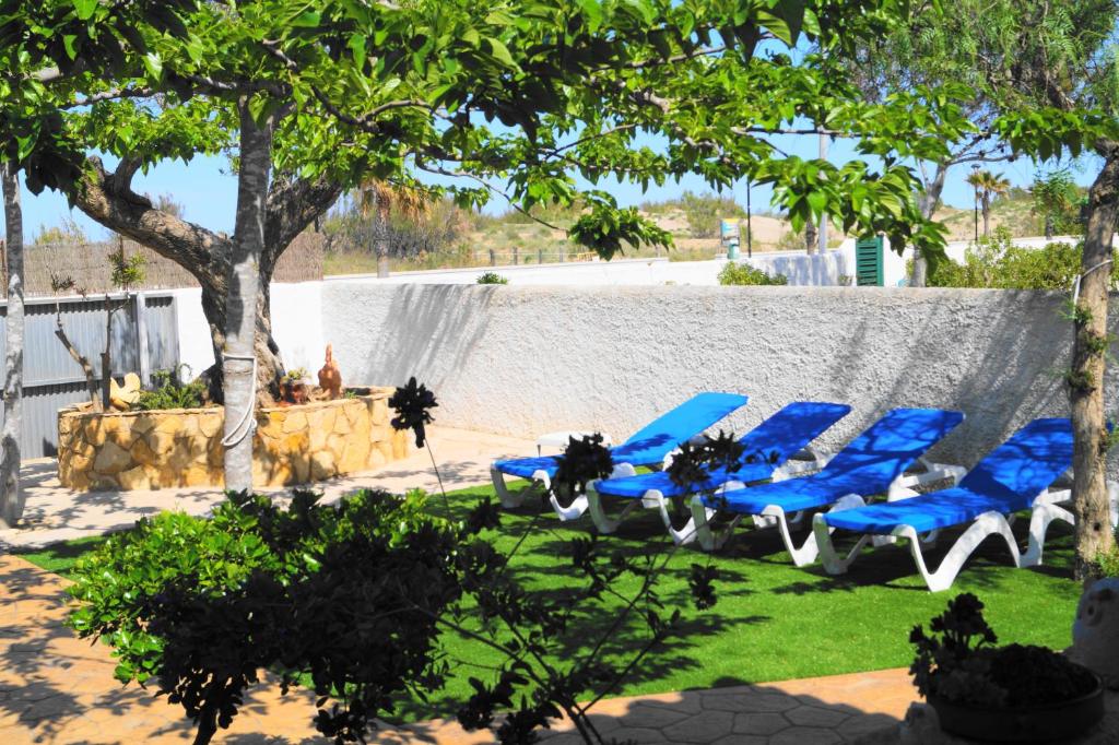a group of blue chairs sitting in a yard at Chalet Marisol Riumar Pura Natura in Riumar