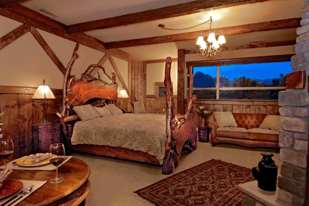 a bedroom with a bed and a couch and a table at Adobe Grand Villas in Sedona