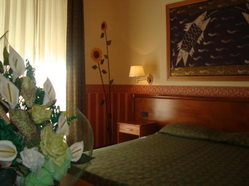 Postel nebo postele na pokoji v ubytování Hotel Verdi