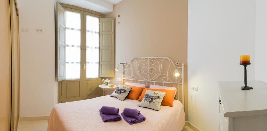 Posteľ alebo postele v izbe v ubytovaní MALAMA Apartamentos Turísticos