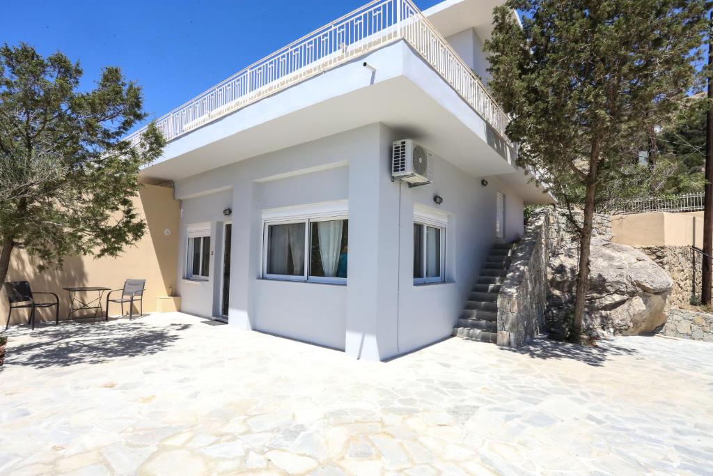 a villa with a staircase and a house at Skouros Villa in Kastrí