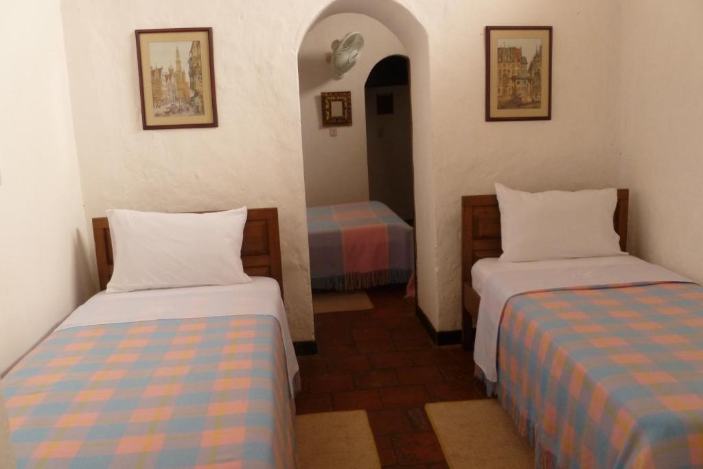 Postel nebo postele na pokoji v ubytování Hotel Mision Santa Barbara RNT 4799