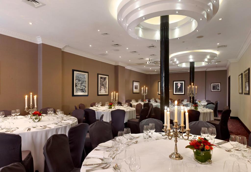 a conference room with tables and chairs with candles at Montcalm Brewery, London City in London