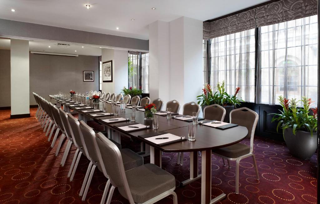 a long dining room with a long table and chairs at Montcalm Brewery, London City in London