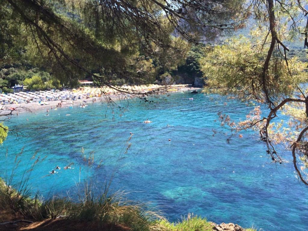 a beach with people swimming in the water at Thea Maris in Maratea