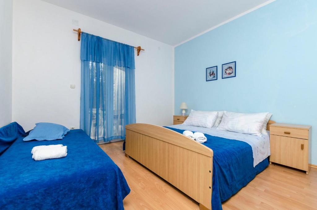 Postel nebo postele na pokoji v ubytování Apartments Helena