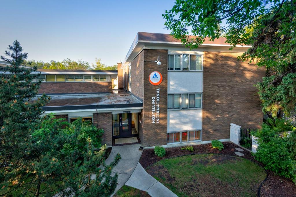 a building with a sign on the side of it at HI Edmonton - Hostel in Edmonton