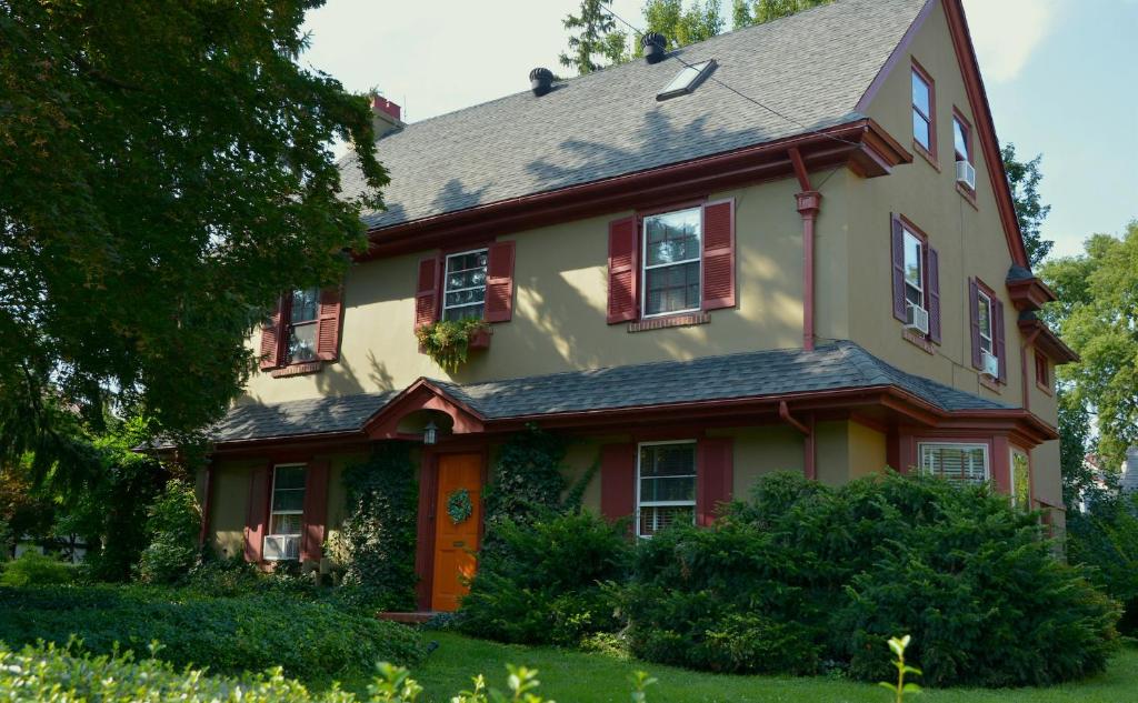 a yellow and red house with red shutters at The Lancaster Bed and Breakfast in Lancaster