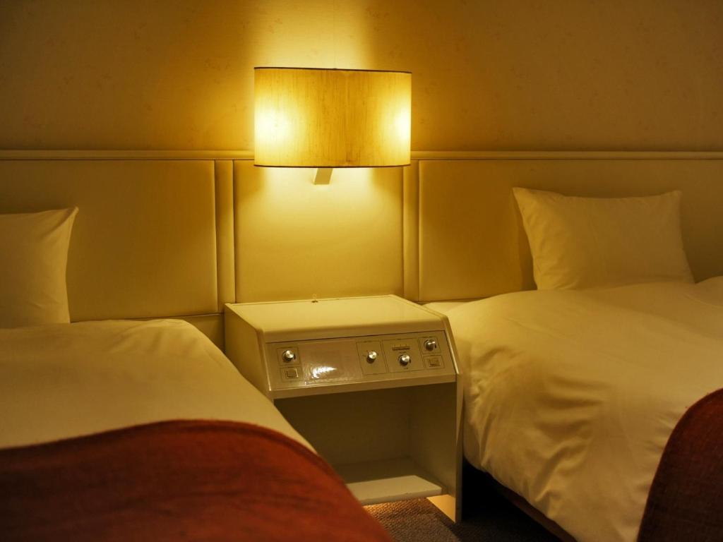 Postel nebo postele na pokoji v ubytování LiVEMAX Resort Atami Forest