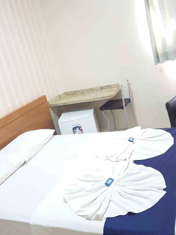 Postel nebo postele na pokoji v ubytování Hotel Astória Maringá