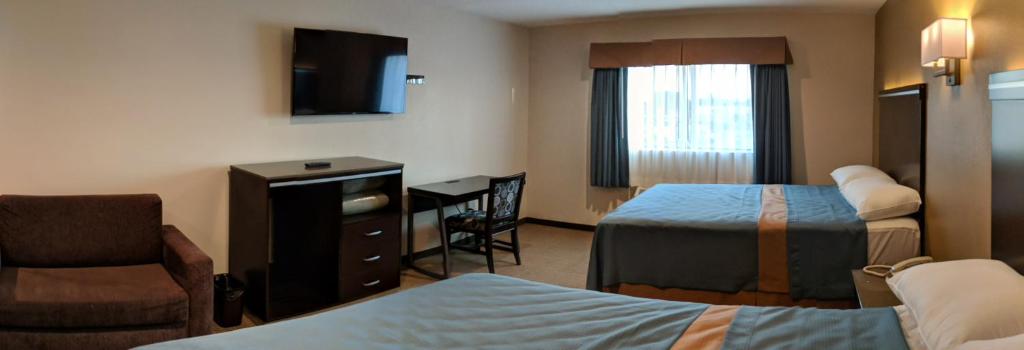Postel nebo postele na pokoji v ubytování Epic Hotel