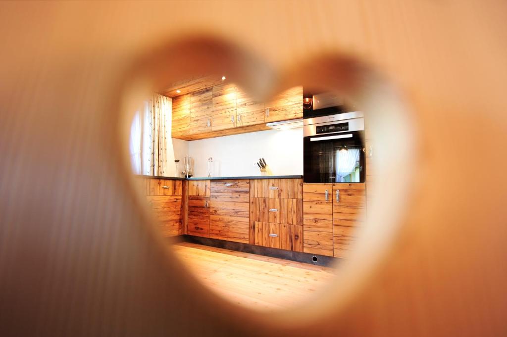 a view of a kitchen through a hole in a wall at Chalet Fuhrmannslochhof in Nauders