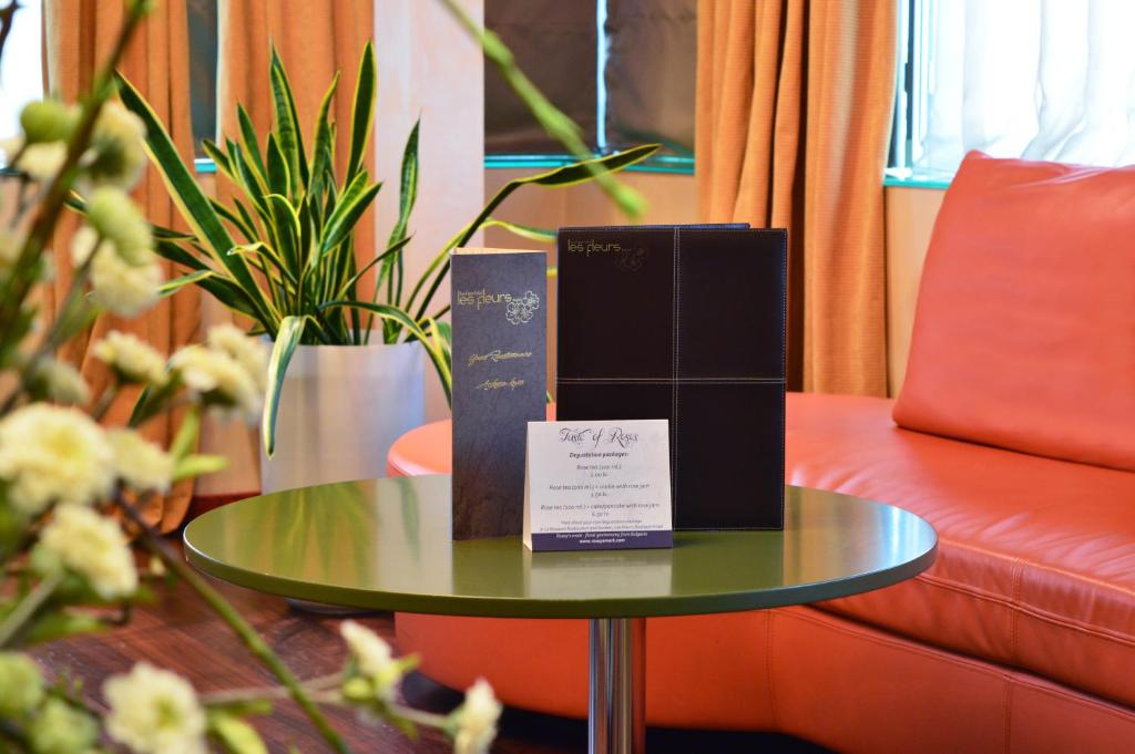 a table with boxes on it next to a couch at Les Fleurs Boutique Hotel in Sofia